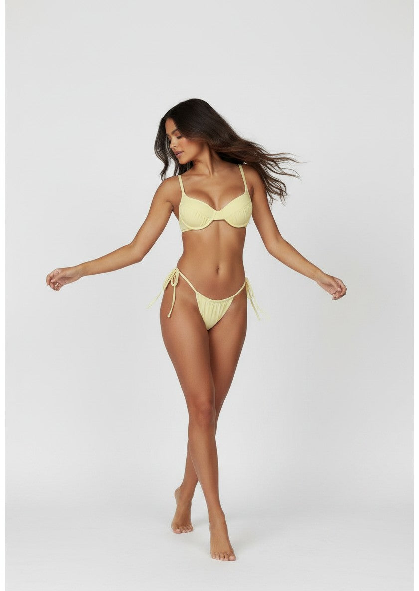 Belezini pastel yellow underwire bikini set with adjustable tie-side bottoms and ruched detailing.